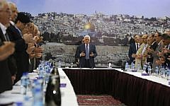 Illustrative: Palestinian Authority President Mahmoud Abbas and his government recite a prayer during a meeting in Ramallah on September 11, 2014. (AFP/Abbas Momani)