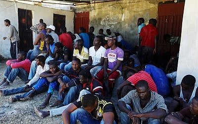 Illegal migrants rest after they were rescued by the Libyan coastguard when their boat sank off the coastal town of Garabulli, 60 km east of Tripoli on September 15, 2014. (photo credit: AFP Photo/Mahmud Turkia)