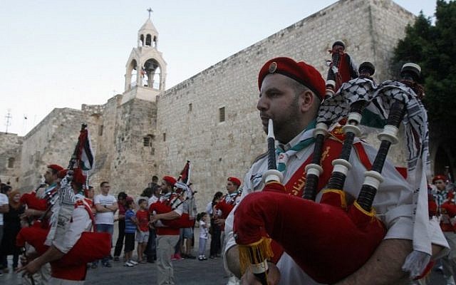 Palestinian scouts play the bagpipes during celebrations in front of the Church of the Nativity in Bethlehem in 2012. (photo credit: AFP Photo/Musa aL-Shaer)