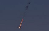 A Syrian fighter jet is seen in flames after it was hit by the Israeli military over the Golan Heights on September 23, 2014. (photo credit: AFP/JALAA MAREY)