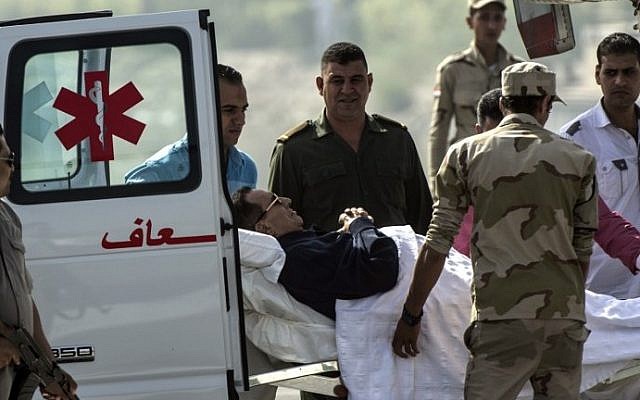 Former Egyptian president Hosni Mubarak is wheeled out of an ambulance outside the Maadi military hospital in Cairo on September 27, 2014, before boarding a helicopter that transported him to court. (photo credit: AFP/Khaled Desouki) Former Egyptian president Hosni Mubarak is wheeled out of an ambulance outside the Maadi military hospital in Cairo on September 27, 2014, before boarding a helicopter that transported him to court. (photo credit: AFP/Khaled Desouki)