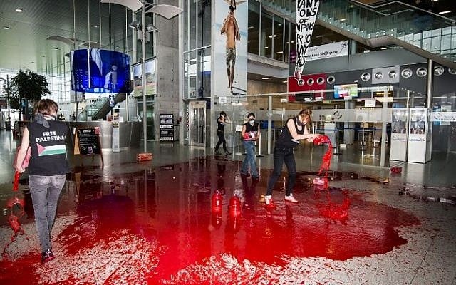 Women's rights movement Liliths' members, a Belgian former branch of the Femen, throw fake blood in the hallway of Liege airport to protest against Israel's military operation in Gaza, on August 26, 2014. (Photo credit: AFP / BELGA / NICOLAS LAMBERT)