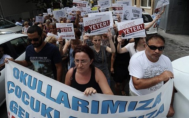 Protesters march with placards reading "enough! Don't turn our schools to Imam Hatips" on August 25, 2014 at Kadikoy in Istanbul. (photo credit: AFP Photo/Ozan Kose) Protesters march with placards reading "enough! Don't turn our schools to Imam Hatips" on August 25, 2014 at Kadikoy in Istanbul. (photo credit: AFP Photo/Ozan Kose)