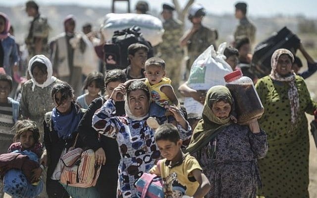 Syrian Kurds cross the border from Syria into Turkey near the southeastern town of Suruc in Sanliurfa province, September 20, 2014. (photo credit: AFP/Bulent Kilic) Syrian Kurds cross the border from Syria into Turkey near the southeastern town of Suruc in Sanliurfa province, September 20, 2014. (photo credit: AFP/Bulent Kilic)