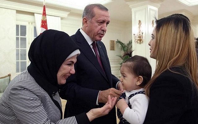 Turkish President Recep Tayyip Erdogan (2nd left) and his wife Emine (left) greeting some of the freed Turkish consulate hostages at the Cankaya presidential palace in Ankara, on September 21, 2014. (photo credit: AFP/Turkish Presidential Press Office/Kayhan Ozer) Turkish President Recep Tayyip Erdogan (2nd left) and his wife Emine (left) greeting some of the freed Turkish consulate hostages at the Cankaya presidential palace in Ankara, on September 21, 2014. (photo credit: AFP/Turkish Presidential Press Office/Kayhan Ozer)