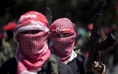Masked Palestinian gunmen of the Popular Front for the Liberation of Palestine (PFLP) in Gaza City during a rally on September 2, 2014, to celebrate the Egypt-mediated ceasefire between Israel and Hamas. (photo credit: AFP/Mahmud Hams)