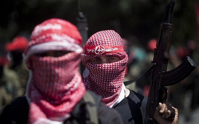 Masked Palestinian gunmen of the Popular Front for the Liberation of Palestine (PFLP) in Gaza City during a rally on September 2, 2014, to celebrate the Egypt-mediated ceasefire between Israel and Hamas. (photo credit: AFP/Mahmud Hams)