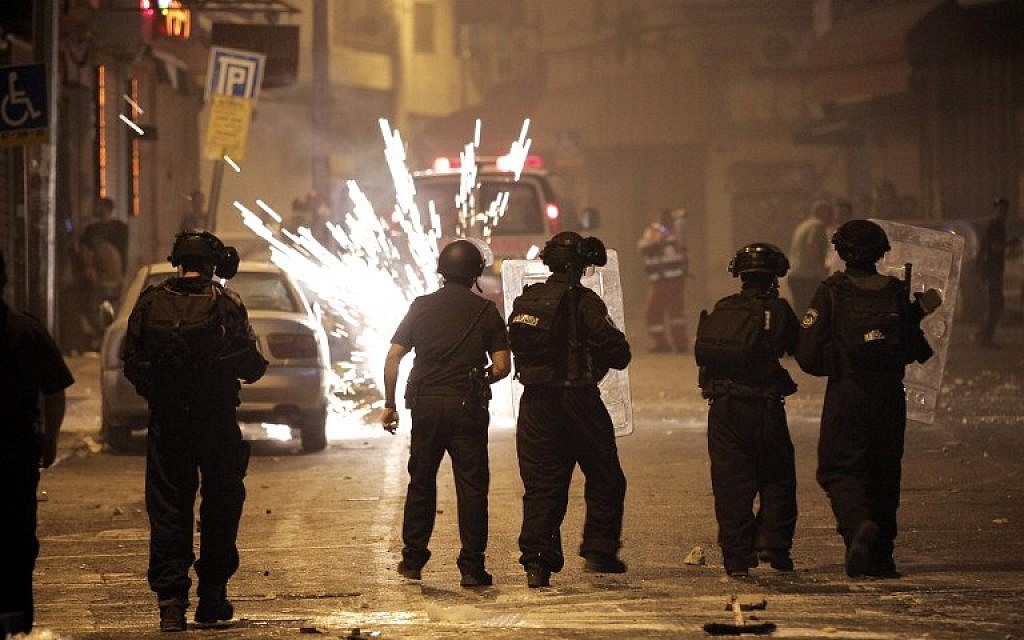 Israeli police face off against Palestinians in East Jerusalem after the funeral of teenager Mohammed Sinokrot, 16 (photo credit: AFP/AHMAD GHARABLI) Israeli police face off against Palestinians in East Jerusalem after the funeral of teenager Mohammed Sinokrot, 16 (photo credit: AFP/AHMAD GHARABLI)