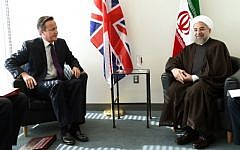 British Prime Minister David Cameron (L) meets with Iranian President Hassan Rouhani at the UN during the 69th Session of the UN General Assembly September 24, 2014 in New York. (photo credit: AFP/Timothy A. CLARY)