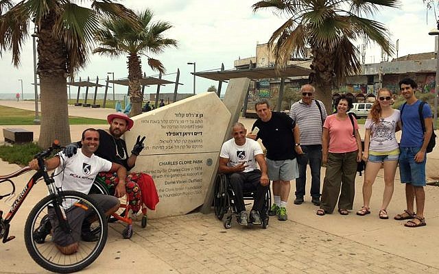 Gabriel Cordell (sixth from right) and supporters at Roll For Peace finish line at Charles Clore Park in Tel Aviv, September 29, 2014. (Courtesy of RollWithMe.org)