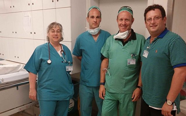 Members of the EVP medical team at Barzilai Medical Center pose with EVP CEO Adi Zahavi (right) before assisting Israeli medical staff in the OR. From left: Wendi Schambach (RN, Texas), Scott Goldstein (paramedic, Baltimore) and Scott Weiner (paramedic, Baltimore). (Courtesy) Members of the EVP medical team at Barzilai Medical Center pose with EVP CEO Adi Zahavi (right) before assisting Israeli medical staff in the OR. From left: Wendi Schambach (RN, Texas), Scott Goldstein (paramedic, Baltimore) and Scott Weiner (paramedic, Baltimore). (Courtesy)