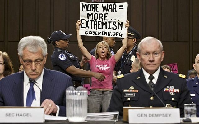 Members of the anti-war activist group CodePink interrupt a Senate Armed Services Committee hearing with Defense Secretary Chuck Hagel, left, and Army Gen. Martin Dempsey, chairman of the Joint Chiefs of Staff, on Capitol Hill in Washington, Tuesday, Sept. 16, 2014. (AP Photo/J. Scott Applewhite) Members of the anti-war activist group CodePink interrupt a Senate Armed Services Committee hearing with Defense Secretary Chuck Hagel, left, and Army Gen. Martin Dempsey, chairman of the Joint Chiefs of Staff, on Capitol Hill in Washington, Tuesday, Sept. 16, 2014. (AP Photo/J. Scott Applewhite)