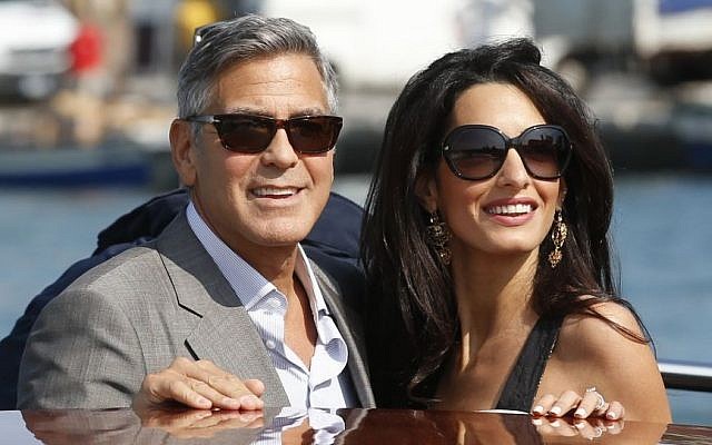 George Clooney, left, and Amal Alamuddin arrive in Venice, Italy, Friday, Sept. 26, 2014, ahead of their wedding. (photo credit: AP Photo/Luca Bruno) George Clooney, left, and Amal Alamuddin arrive in Venice, Italy, Friday, Sept. 26, 2014, ahead of their wedding. (photo credit: AP Photo/Luca Bruno)