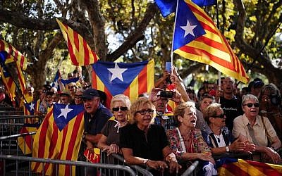 People wave 'estelada' flags, symbolizing Catalonia's independence during a demonstration calling for the independence of Catalonia in Barcelona, Spain, Friday, Sept. 19, 2014. (Photo credit: AP/Manu Fernandez)