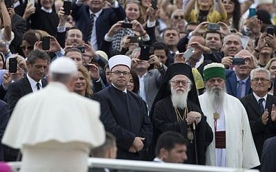Albanian religious leaders look at Pope Francis arriving for a Mass in mother Teresa square, Tirana, on Sunday, September 21, 2014. (photo credit: AP Photo/Alessandra Tarantino)