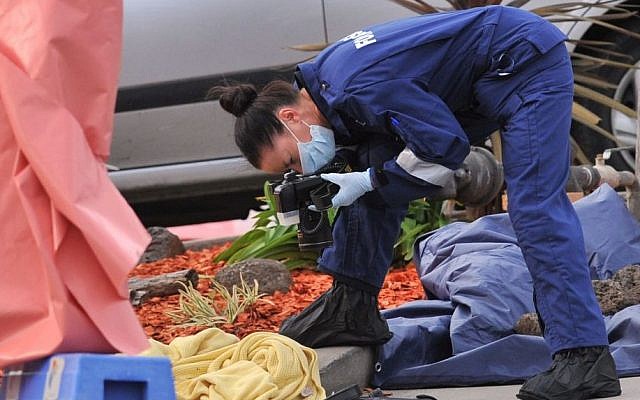 A forensic officer documents objects including a blanket at the scene of a fatal shooting at Endeavour Hills Police Station in Melbourne, Wednesday, Sept. 24, 2014 (Photo credit: Julian Smith/AP/AAP Image) A forensic officer documents objects including a blanket at the scene of a fatal shooting at Endeavour Hills Police Station in Melbourne, Wednesday, Sept. 24, 2014 (Photo credit: Julian Smith/AP/AAP Image)