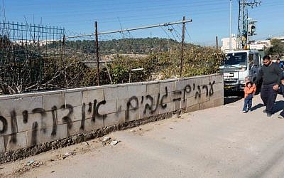 The New Israel Fund says it is getting more aggressive in combating xenophobia and ultranationalism. This anti-Arab graffiti reading 'Arabs = thieves. No coexistence' is seen spray-painted on a stone wall surrounding a house in the eastern Jerusalem neighborhood of Sharafat, Feb. 18, 2014. (FLASH90/JTA)
