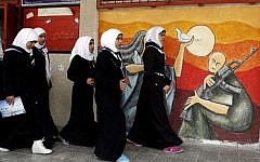 Palestinian girls walk during an awareness training session on the dangers of unexploded ordinances on April 7, 2014, at a school in Khan Younis (photo credit: Abed Rahim Khatib/Flash90)