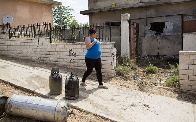 A woman passes a house following a rocket attack in the southern Israeli town of Sderot, on July 21, 2014. (Photo credit: Yonatan Sindel/Flash90) A woman passes a house following a rocket attack in the southern Israeli town of Sderot, on July 21, 2014. (Photo credit: Yonatan Sindel/Flash90)