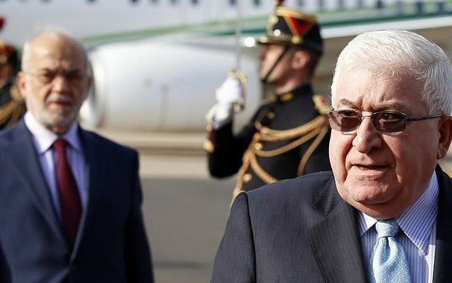 Iraq President Fouad Massoum, right, followed by Iraq Foreign Minister Ibrahim Al-Jaafari, left, arrive with Iraqi officials at Orly airport south of Paris, France, Sunday, Sept. 14, 2014 ahead of a conference with US Secretary of State John Kerry, French President Francois Hollande and diplomats from around the world. The conference on Monday aimed at helping Iraq fight off extremists from the Islamist State group, with an added urgency following the release of a video showing the beheading of a British aid worker, the third Western hostage killed in recent weeks by the militants. (Photo credit: AP/Francois Mori)
