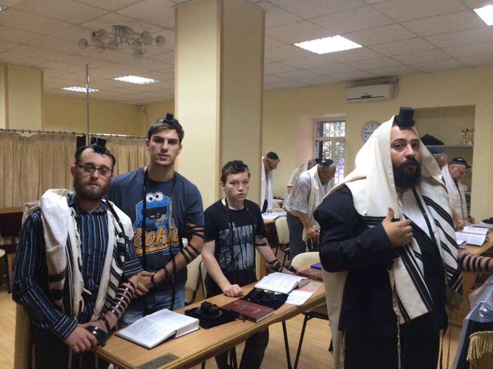 Chabad Rabbi Mendel Cohen (far right) and his three-times daily minyan in Mariupol. (courtesy)
