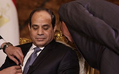Egyptian President Abdel-Fattah el-Sissi confers with an aide before an interview at the presidential palace in Cairo, Saturday, Sept. 20, 2014 (photo credit: AP/Maya Alleruzzo)
