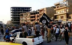 Fighters from the Islamic State parade in Raqqa, Syria (photo credit: AP/Raqqa Media Center of the Islamic State group, File)