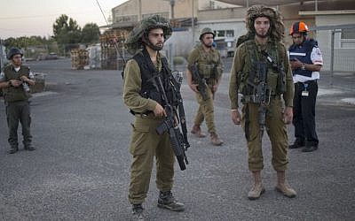 FILE - In this file photo taken Wednesday, Aug. 27, 2014, Israeli soldiers secure an area where a mortar which was fired during clashes between Syrian rebels and President Bashar Assad’s forces in the Quneitra province hit in a community in the Israeli-controlled Golan Heights. (Photo credit: AP/Ariel Schalit)