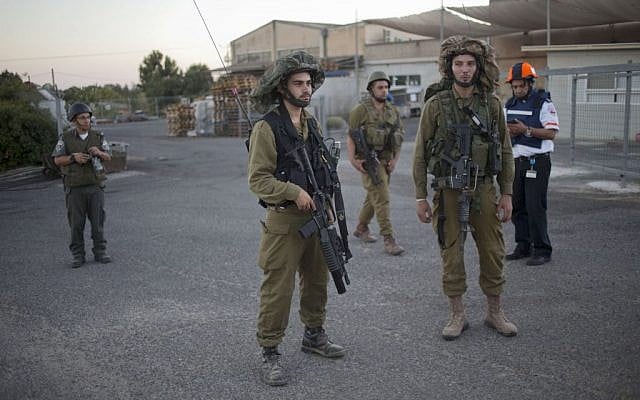 In this file photo taken Wednesday, August 27, 2014, Israeli soldiers secure an area where a mortar which was fired during clashes between Syrian rebels and President Bashar Assad’s forces in the Quneitra province hit in a community in the Israeli-controlled Golan Heights. (photo credit: AP/Ariel Schalit) In this file photo taken Wednesday, August 27, 2014, Israeli soldiers secure an area where a mortar which was fired during clashes between Syrian rebels and President Bashar Assad’s forces in the Quneitra province hit in a community in the Israeli-controlled Golan Heights. (photo credit: AP/Ariel Schalit)
