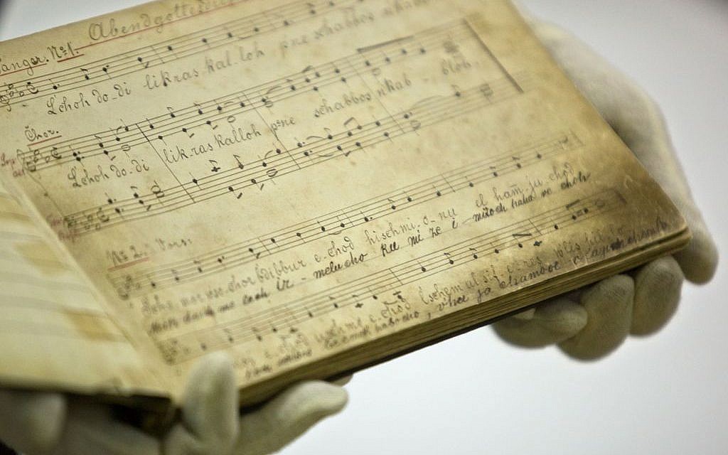 Yad Vashem archive director Haim Gertner shows a musical score with German lyrics at the Yad Vashem Holocaust memorial archives in Jerusalem. September 8, 2014. (photo credit: AP/Sebastian Scheiner)