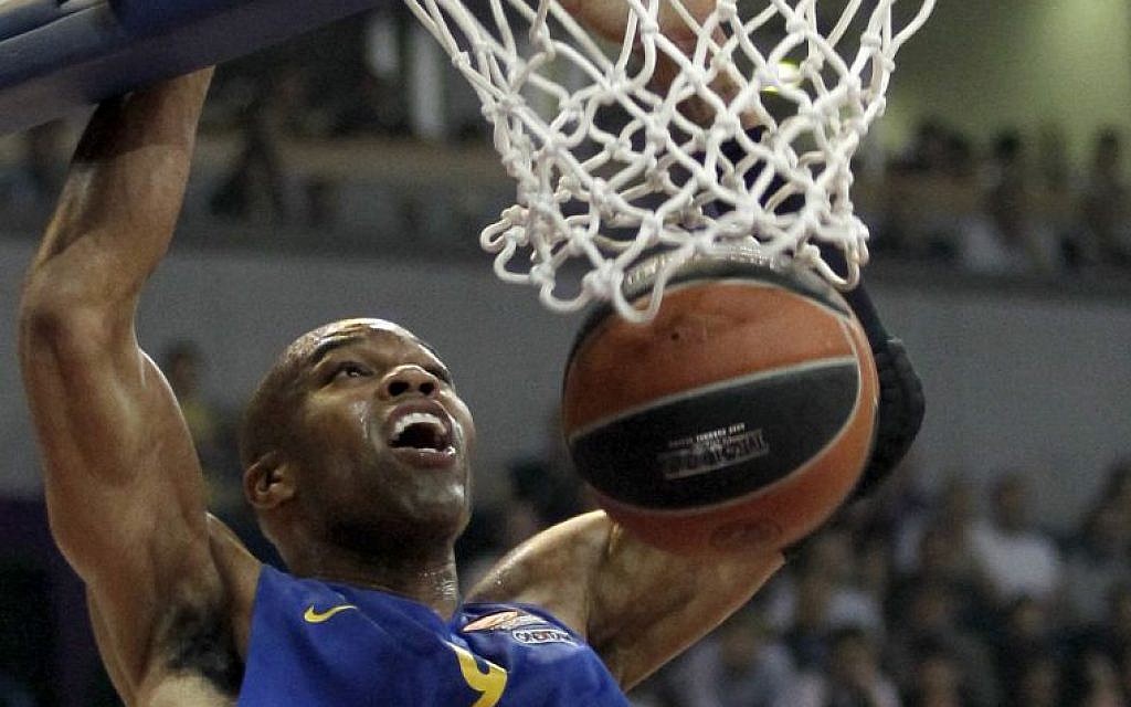 In this Thursday, March 20, 2014 file photo, Alex Tyus of Israel's BC Maccabi Electra dunks a ball during their Euroleague Top 16 basketball match against Partizan, in Belgrade, Serbia, Thursday, March 20, 2014. With his Maccabi Tel Aviv team set to face LeBron James in his first game back for the Cleveland Cavaliers on Oct. 5, 2014, Alex Tyus, a 6-9 power forward from St. Louis, has an important decision to make -- whether to fast the previous day for the Jewish holy day of Yom Kippur. American Jews have long found a basketball refuge in Israel but the Jewish state has never seen anything like Tyus before: an African-American standout from a major college program with no previous link to the religion who decided, along with his future wife, to embrace the faith and set off on a path that led him to the Israel national team and the best team in the country. (photo credit: AP Photo/Darko Vojinovic, File) In this Thursday, March 20, 2014 file photo, Alex Tyus of Israel's BC Maccabi Electra dunks a ball during their Euroleague Top 16 basketball match against Partizan, in Belgrade, Serbia, Thursday, March 20, 2014. With his Maccabi Tel Aviv team set to face LeBron James in his first game back for the Cleveland Cavaliers on Oct. 5, 2014, Alex Tyus, a 6-9 power forward from St. Louis, has an important decision to make -- whether to fast the previous day for the Jewish holy day of Yom Kippur. American Jews have long found a basketball refuge in Israel but the Jewish state has never seen anything like Tyus before: an African-American standout from a major college program with no previous link to the religion who decided, along with his future wife, to embrace the faith and set off on a path that led him to the Israel national team and the best team in the country. (photo credit: AP Photo/Darko Vojinovic, File)