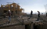 Palestinian laborers working at a construction site in the West Bank settlement of Ma'ale Adumim, near Jerusalem, September 16, 2014. (AP/Dan Balilty)