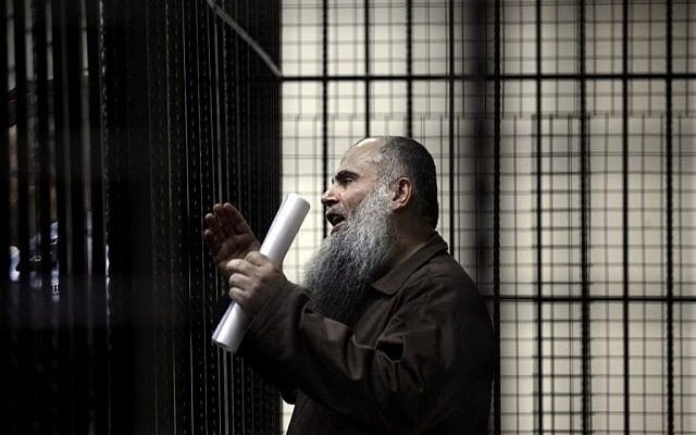 In this Sunday, September 7, 2014 file photo, radical al-Qaeda-linked preacher Abu Qatada speaks to the press prior to his verdict at the Jordanian military court in Amman, Jordan. (photo credit: AP/Mohammad Hannon, File). In this Sunday, September 7, 2014 file photo, radical al-Qaeda-linked preacher Abu Qatada speaks to the press prior to his verdict at the Jordanian military court in Amman, Jordan. (photo credit: AP/Mohammad Hannon, File).