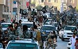 Fighters from the Islamic State group parade in Raqqa, north Syria, in June 2014. (AP/Raqqa Media Center of the Islamic State group/File)
