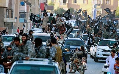 Fighters from the Islamic State group parade in Raqqa, north Syria in June 2014 (Photo credit: AP/Raqqa Media Center of the Islamic State group, File)