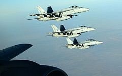 In this Tuesday, Sept. 23, 2014 photo released by the US Air Force, a formation of US Navy F-18E Super Hornets leaves after receiving fuel from a KC-135 Stratotanker over northern Iraq as part of US led coalition airstrikes on the Islamic State group and other targets in Syria. (AP/US Air Force, Staff Sgt. Shawn Nickel)
