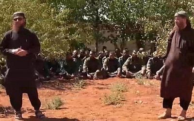 This image made from video posted on a militant social media account on Thursday, Sept. 11, 2014 shows U.N. peacekeepers from Fiji, background, held captive by militants from the Nusra Front in Syria. Al-Qaida-linked Syrian rebels on Thursday released all 45 Fijian peacekeepers they had held captive for two weeks, the United Nations said, bringing an end to a crisis that had pulled the U.N. monitoring force into the chaos of Syria's civil war. (photo credit: AP Photo via militant social media account)