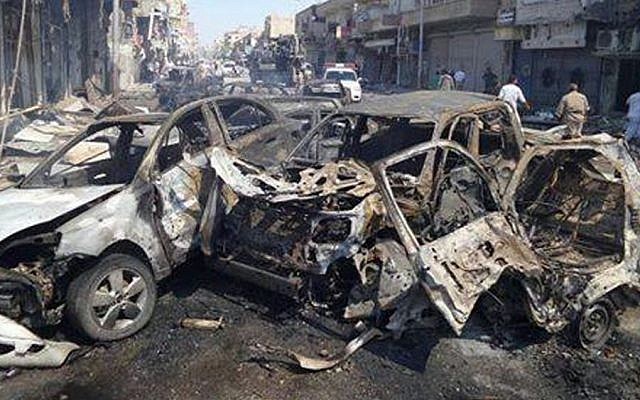 This image posted by the Raqqa Media Center of the Islamic State group, a militant extremist group, which has been authenticated based on its contents and other AP reporting, shows damaged cars that were burned after a Syrian government airstrike in the northeastern city of Raqqa, Syria, Saturday, Sept. 6, 2014. (Photo credit: AP/Raqqa Media Center of the Islamic State group) This image posted by the Raqqa Media Center of the Islamic State group, a militant extremist group, which has been authenticated based on its contents and other AP reporting, shows damaged cars that were burned after a Syrian government airstrike in the northeastern city of Raqqa, Syria, Saturday, Sept. 6, 2014. (Photo credit: AP/Raqqa Media Center of the Islamic State group)