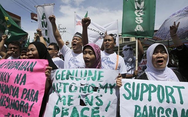 Filipino Muslims shout slogans during a rally near the Presidential Palace in support of the Bangsamoro Basic Law draft that was formally submitted by Philippine President Benigno Aquino III to both houses of Congress Wednesday, Sept. 10, 2014 in Manila, Philippines. (photo credit: AP Photo/Bullit Marquez) Filipino Muslims shout slogans during a rally near the Presidential Palace in support of the Bangsamoro Basic Law draft that was formally submitted by Philippine President Benigno Aquino III to both houses of Congress Wednesday, Sept. 10, 2014 in Manila, Philippines. (photo credit: AP Photo/Bullit Marquez)