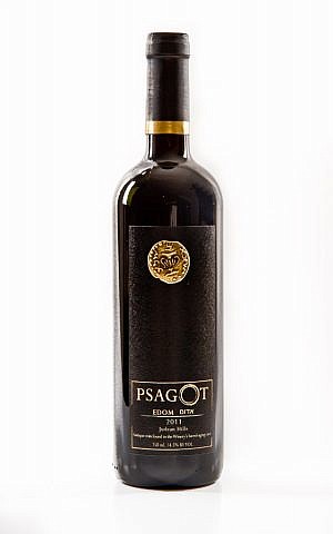 A bottle of a 2011 Psagot Edom, adorned with a copy of the ancient coin found in the cave behind Yaakov Berg's Psagot home (Courtesy Psagot Winery) A bottle of a 2011 Psagot Edom, adorned with a copy of the ancient coin found in the cave behind Yaakov Berg's Psagot home (Courtesy Psagot Winery)