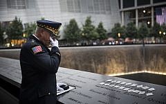 Sam Pulia, mayor of Westchester, Ill., and a former police officer of the same town, mourns over the name of his cousin, New York firefighter Thomas Anthony Casoria, who was killed in the South Tower in the attacks of Sept. 11, 2001, prior to the the memorial observances held at the site of the World Trade Center in New York, Thursday, Sept. 11, 2014 (photo credit: AP/Andrew Burton, Pool)