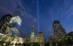 In this Monday, September 8, 2014, photo, the Tribute in Light rises behind buildings adjacent to the World Trade Center in New York. (photo credit: AP/Mark Lennihan)