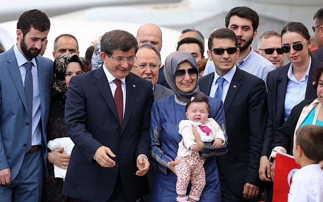 Turkish Prime Minister Ahmet Davutoglu, center left, stands with freed hostages at the airport in Ankara, Turkey, Saturday, Sept. 20, 2014. (Photo credit: AP) Turkish Prime Minister Ahmet Davutoglu, center left, stands with freed hostages at the airport in Ankara, Turkey, Saturday, Sept. 20, 2014. (Photo credit: AP)