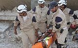 In this photo posted on August 21, 2014, Syrian civil defense rescuers in white helmets carry one of their comrades during a training session, in Idlib province, northern Syria. (AP/Civil Defense Idlib)