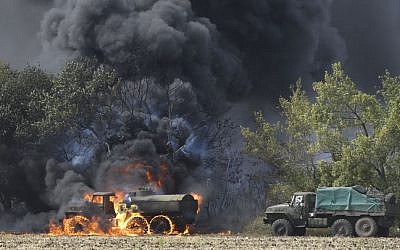 Unmarked Military vehicles burning in country roads in the village of Berezove, eastern Ukraine, on Thursday, September 4, 2014, after a clash between pro-government troops and Russian-backed separatist militia. (photo credit: AP Photo/Sergei Grits)