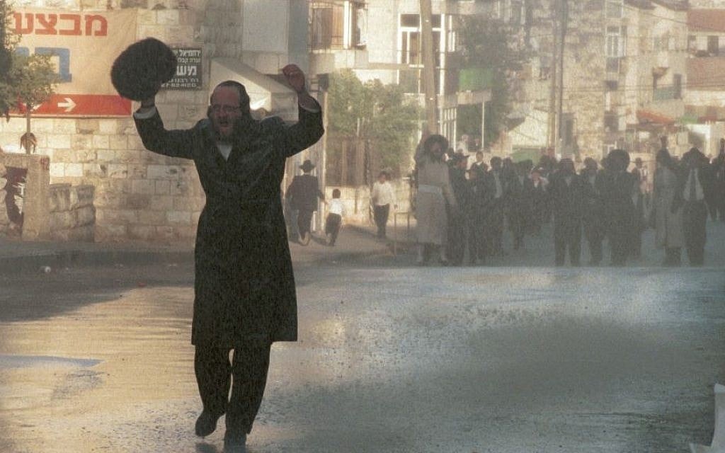 Illustrative photo of an ultra-Orthodox man yelling as he walks in Mea Shearim where police were breaking up a protest using water canon. The protest, in August 1996, was by local ultra-Orthodox residents seeking to close a main road in the area to traffic on Shabbat. (Photo credit: Nati Shohat Flash90) Illustrative photo of an ultra-Orthodox man yelling as he walks in Mea Shearim where police were breaking up a protest using water canon. The protest, in August 1996, was by local ultra-Orthodox residents seeking to close a main road in the area to traffic on Shabbat. (Photo credit: Nati Shohat Flash90)