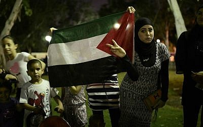 Arab-Israelis protesting Israel’s Gaza operation hold the Palestinian flag at the demonstration in the central Israeli city of Jaffa, near Tel Aviv, July 21, 2014 (photo credit: Tomer Neuberg/Flash90)