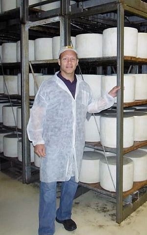 Brent Delman visiting the cheesemaking facility in Sardinia, Italy, that prepares the kosher Pecorino Romano type he sells in the United States. (Courtesy Brent Delman/JTA)