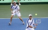 Jonathan Erlich watches as his team mate Andy Ram, of Israel, returns the ball to the team from Argentina during the Davis Cup match in Sunrise, Florida, on Saturday, September 13, 2014. (photo credit: AP/J. Pat Carter)