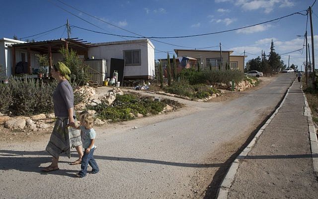 A woman seen walking with young children in the streets of the settlement of G'vaot on September 2, 2014. (Photo credit: Miriam Alster/FLASH90) A woman seen walking with young children in the streets of the settlement of G'vaot on September 2, 2014. (Photo credit: Miriam Alster/FLASH90)